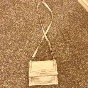 A very cute, silver, small UNLIMITED bag
